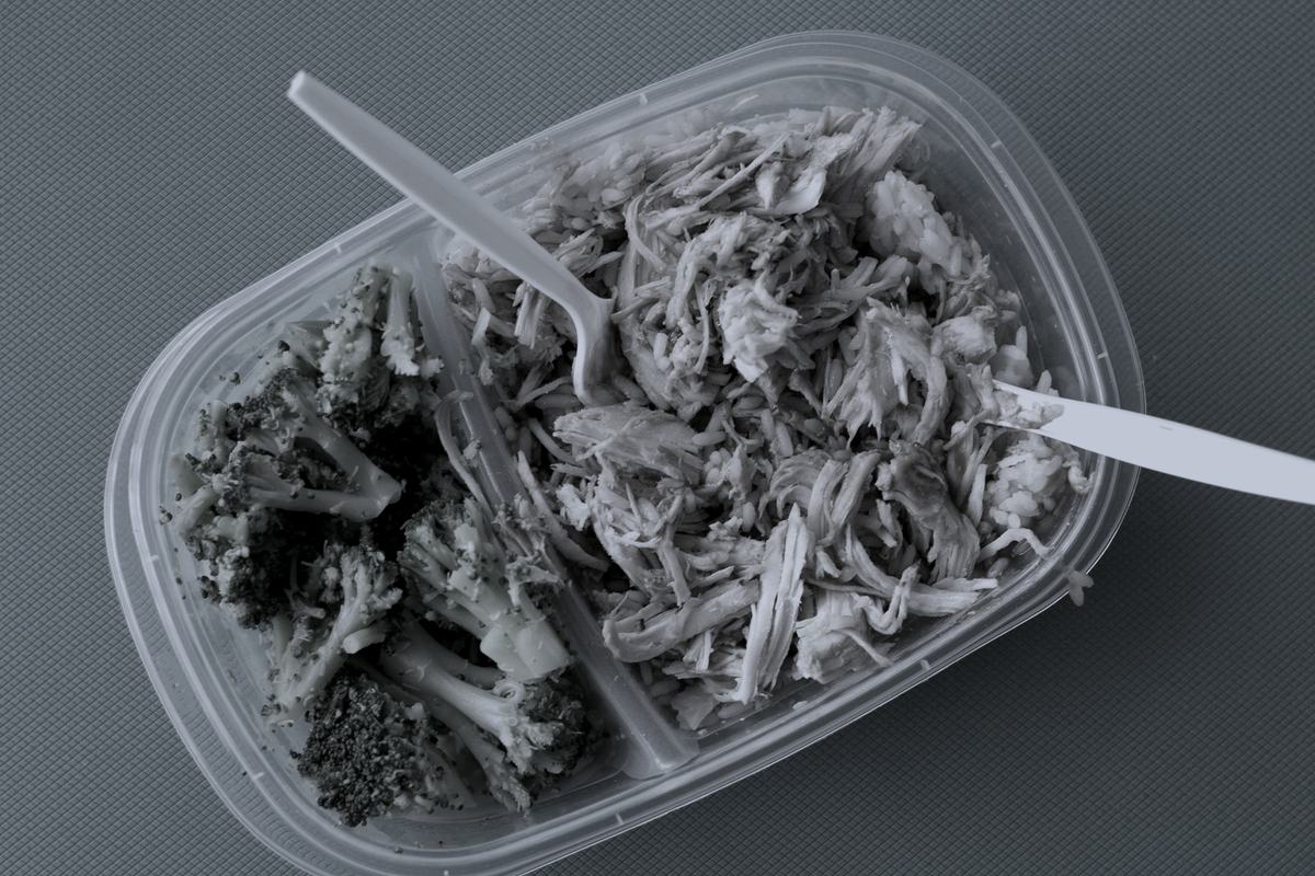 A packed container of shredded chicken and broccoli.