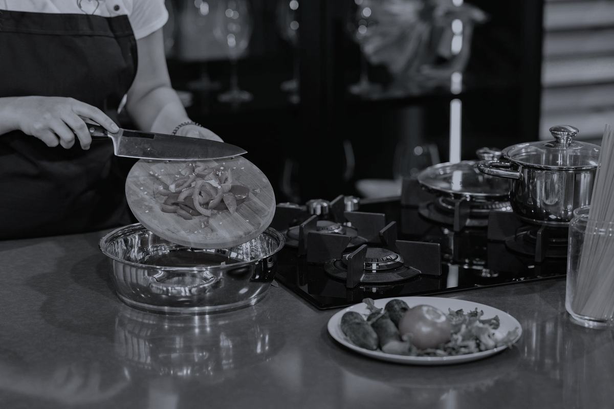 A person preparing vegetables on a kitchen counter.